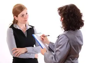 Supervisor taking notes while listening to employee