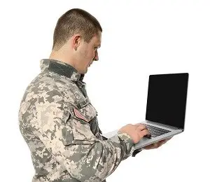 Military servicemember holding laptop