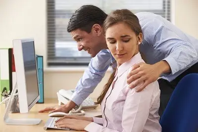 Office worker with hand-on female colleague's shoulder