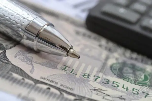 Pen and a calculator on top of money - claimants under the California False Claims Act may be entitled to significant damages