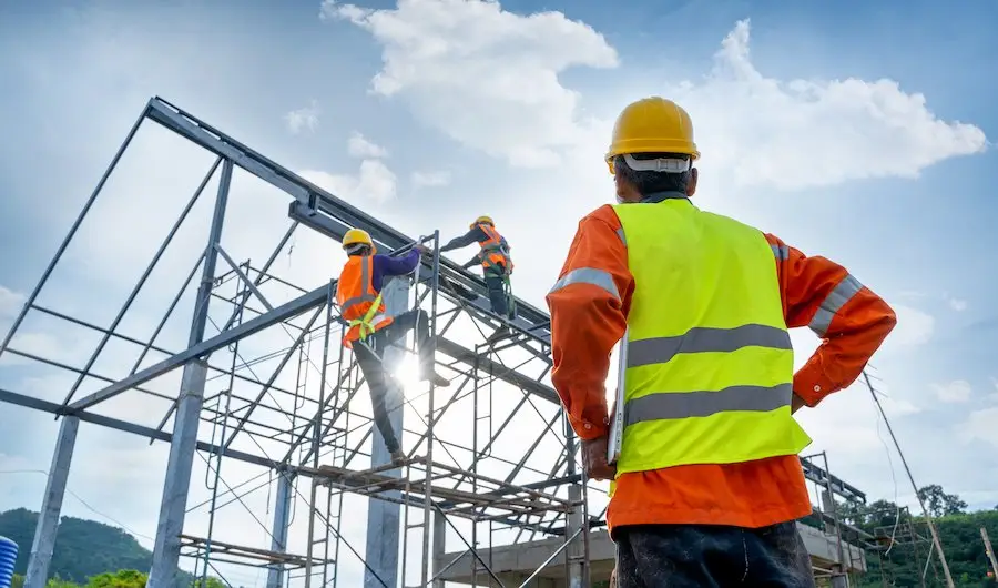 Construction workers building an outdoor structure and earning wages in accordance with Wage Order 16.
