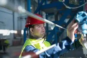 Young man with Down syndrome working in industrial factory