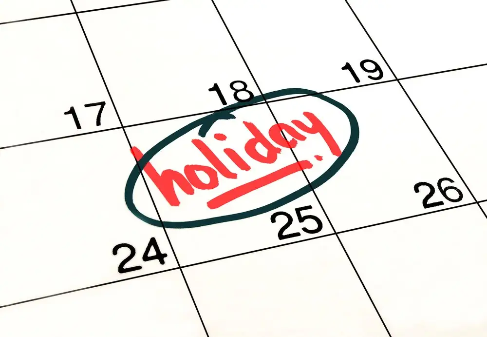 A date circled on a white and black calendar inscribed "Holiday" in a red marker