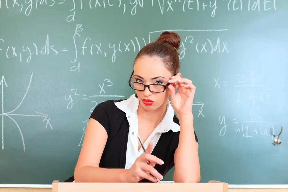 Naughty teacher lowering her glasses.