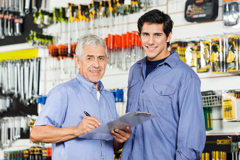 A father and son going through their daily check list at their family business. 