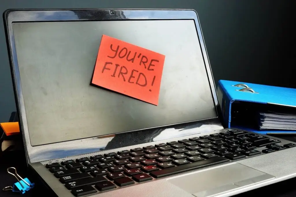 Laptop with post-it that says you're fired, which would be unlawful in California if the employer's motivation is the employee's political beliefs