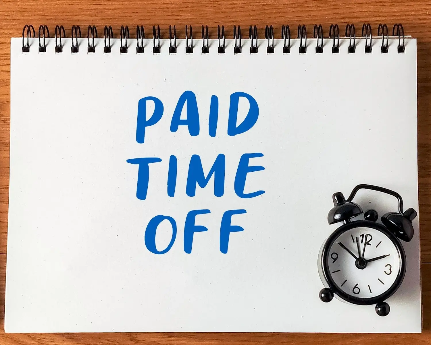 Sign that says "paid time off" next to an alarm clock