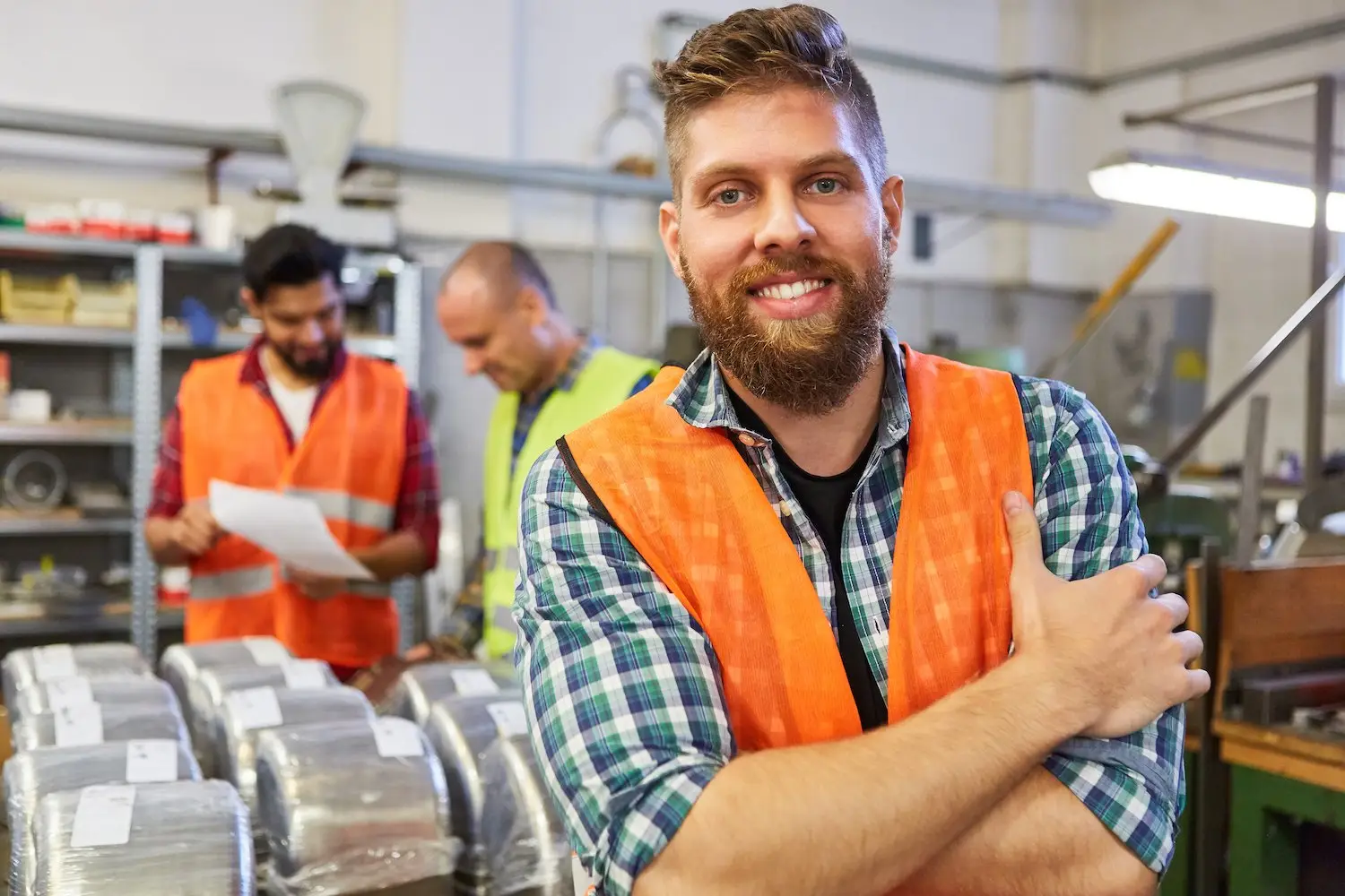 Happy blue-collar worker in his warehouse smiling because he got his paycheck