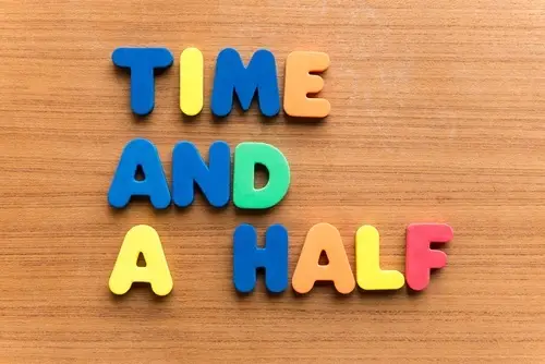 Wooden table with block letters that read "Time and a Half"