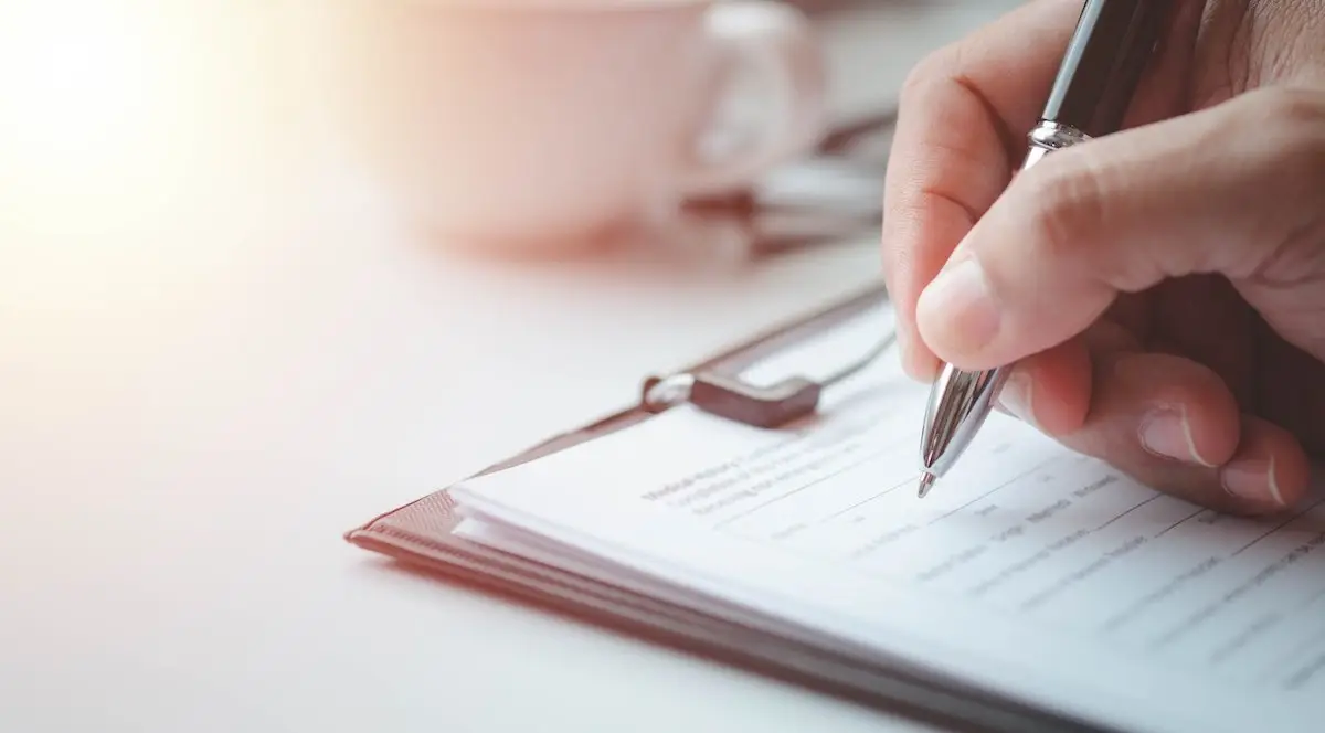 Man signing an employment agreement with a ballpoint pen