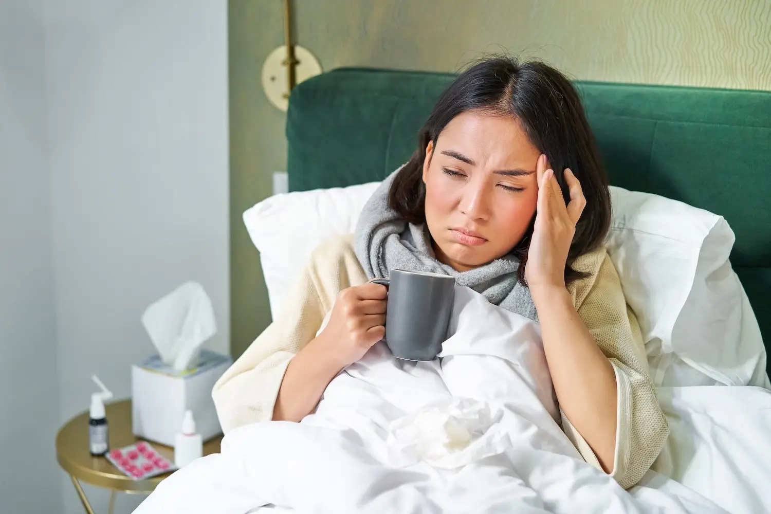Employer home sick in bed with a mug of tea