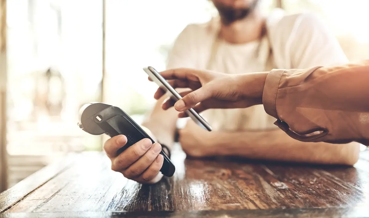 Customer paying a tip by credit card using a portable device