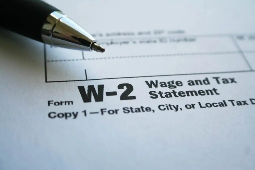 Closeup of W-2 Wage and Tax Statement form with a ballpoint pen resting on it