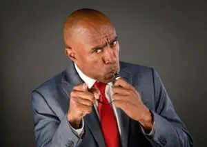 Man in business suit blowing a whistle