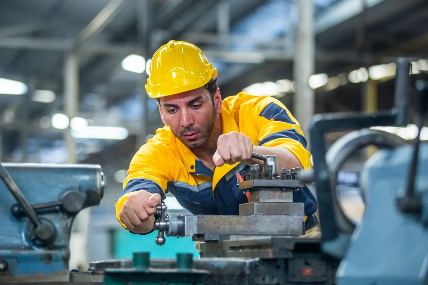 Employee in hard hat at work in a factory