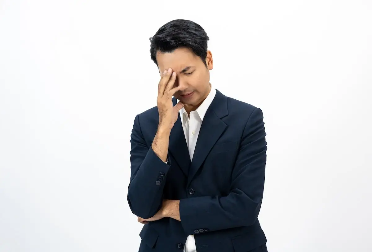 Distressed worker in a business suit against a white background